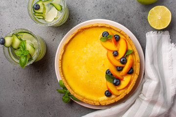 Homemade tart with cream brûlée and fruits and cold drinks. Copy space.