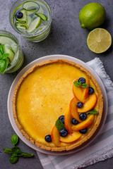 Homemade tart with cream brûlée and fruits and cold drinks.
