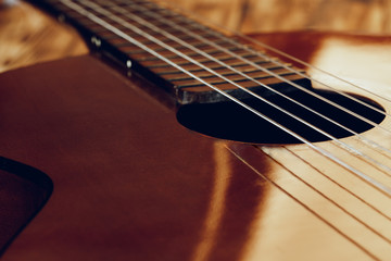 Fototapeta premium Wooden acoustic guitar body and fingerboard close up