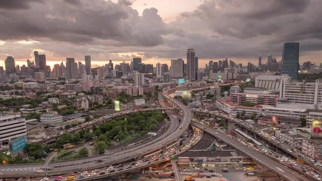 Time lapse Aerial view and top view of traffic on city streets in Bangkok , Thailand. Expressway with car lots. Beautiful roundabout road in the city center.