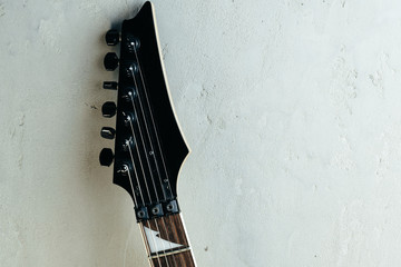 Guitar headstock with tuners on dark background