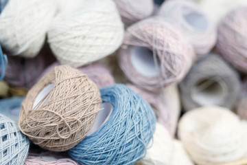 Fototapeta na wymiar Colored beige balls of yarn. Knitting or crocheting for handmade winter clothes.