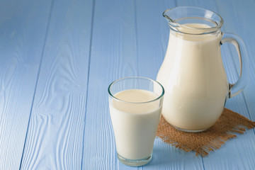 Glass of milk on table close up