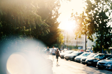 Beautiful blurred image, urban background and texture. City at sunset, street pedestrians and cars