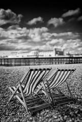 Brighton, England - September 11, 2009: Empty Deckchairs on Beach next to Brighton Pier, First...