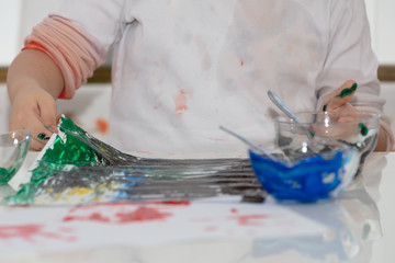 Child Finger Painting at home On Paper at covid time . stay at home