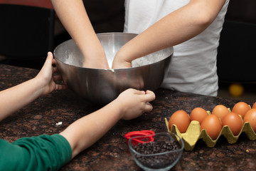 Kids baking cookies in house kitchen . Close-up child`s hands preparing cookies using cookie.