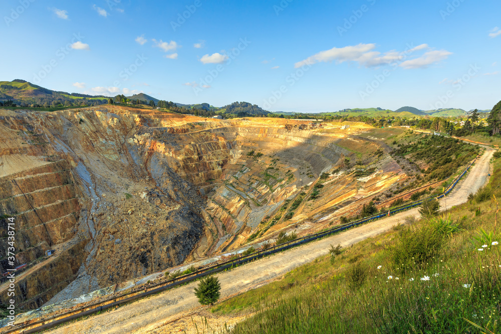 Wall mural a large open-cast gold mine at waihi, new zealand. a slip has cascaded down the terraced side of the