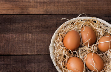 Close-up of fresh brown chicken eggs on a wooden table with a copy of the space