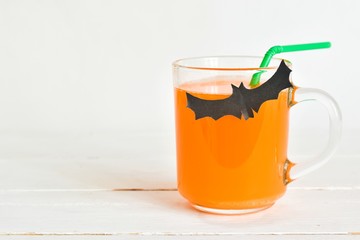 Festive homemade Halloween cocktail.
Cute Halloween drinks for a kids party on white wooden background. Concept holiday, Halloween.