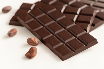 Bar of chocolate and cocoa beans.