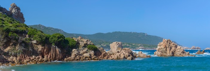 Beautiful shot of rock formations near the sea close to Beach Li Cossi, Sardinia, Italy.