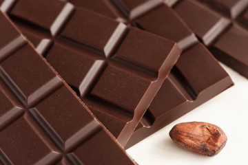 Bar of chocolate and cocoa beans.