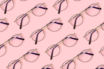 Eyeglasses pattern on a pink pastel background. Fashion accessories layout.