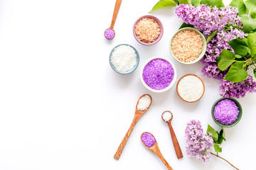 Sea salt spa set with pink lilac flowers. Top view
