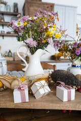 Autumn interior and still life. Pumpkins, apples, zucchini, autumn leaves and flowers. Background. Postcard. Flat lay.