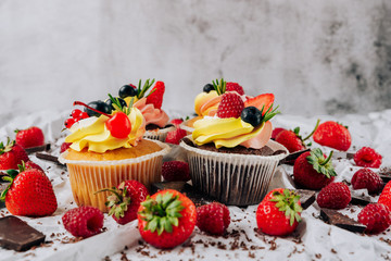 chocolate cupcakes with cream and fresh berries