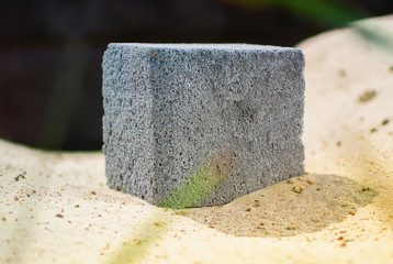 Cubic piece of foam concrete example on a tree. Ecology