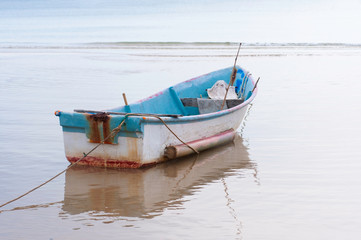 Vintage floating boat sea on beach with anchor, sea light in morning.