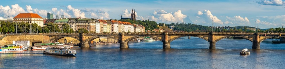 Obraz na płótnie Canvas The famous Prague Bridges on a beautiful summer afternoon-panorama