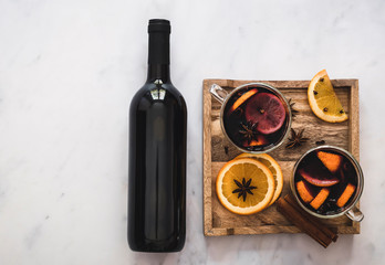 Hot holiday drink mulled wine with oranges, gloves, anise stars, and cinnamon.