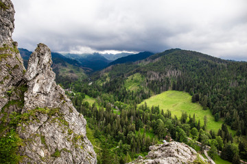 Rocky landscape in the mountains. Travel adventure hikking scenery in the summer. Greeen valley withy wild forest.