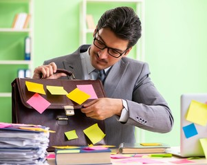 Businessman unhappy with many conflicting priorities sitting in