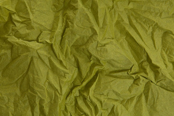 The crumpled paper background top view. Green colors.