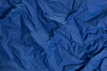 The crumpled paper background top view. Blue colors.