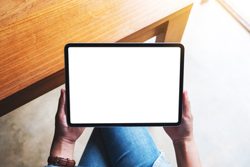 Top view mockup image of a woman holding digital tablet with blank white desktop screen