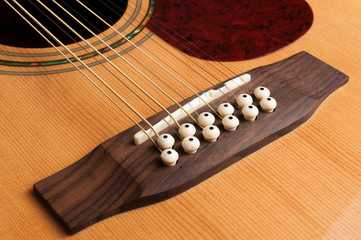 Detail of the bridge of a 12-string guitar
