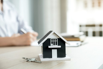 Home model standing in front of a real estate agent explain the business contract, rent, buy, mortgage, loan, or home insurance to the buyer