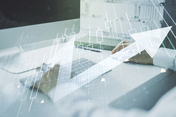 Double exposure of abstract creative financial diagram with upward arrow and hands typing on computer keyboard on background, growth and development concept