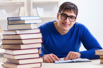 Male student preparing for exams in college library