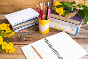 notebook ,dictionary english and all book for study of student  with stationary ,yellow flowers...