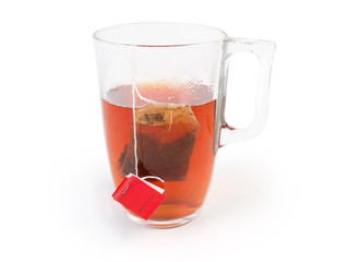Freshly brewed black tea in glass cup with tea bag