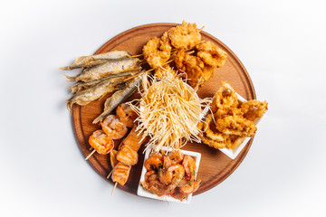 Isolated fried beer platter with fish and shrimps