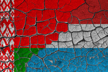 Flags of Belarus and 
Luxembourg, Netherlands on a cracked wall, dry land. Concept of relationship or conflict between countries	