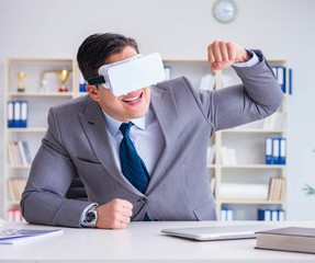 Businessman with virtual reality glasses in modern technology co