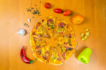 Pizza dough with tomato sauce on a rustic table