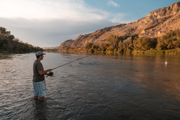 Fototapeta na wymiar river fisherman with fishing rod