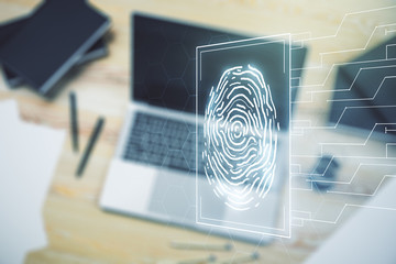 Double exposure of abstract creative fingerprint hologram on laptop background, research and development concept