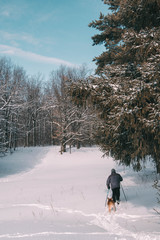 man walking in winter forest