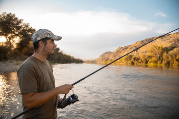 river fisherman with fishing rod