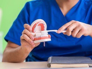 Man dentist working on new teeth implant