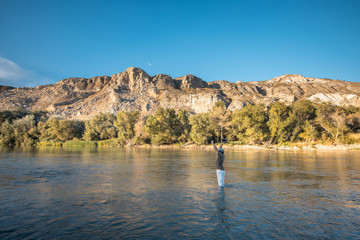 river fisherman with fishing rod