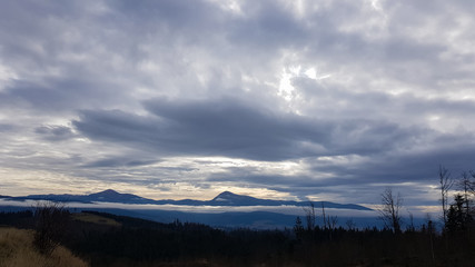 Colorful autumn landscape in the Carpathian mountains with mountain peaks. Carpathians, Ukraine, Europe. World of beauty. Forest with orange leaves. Autumn sunny day in western Ukraine.