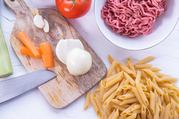 Pasta, minced meat, onion and other vegetables to cook Italian bolognesa. Healthy cuisine. Top view.