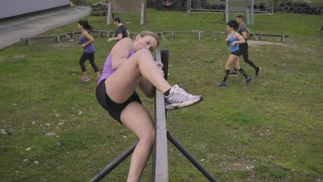 Group of participants in an obstacle course climbing wall