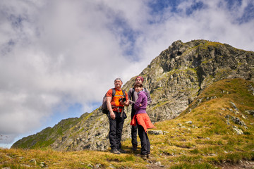 Fototapeta na wymiar Family of hikers into the mountains